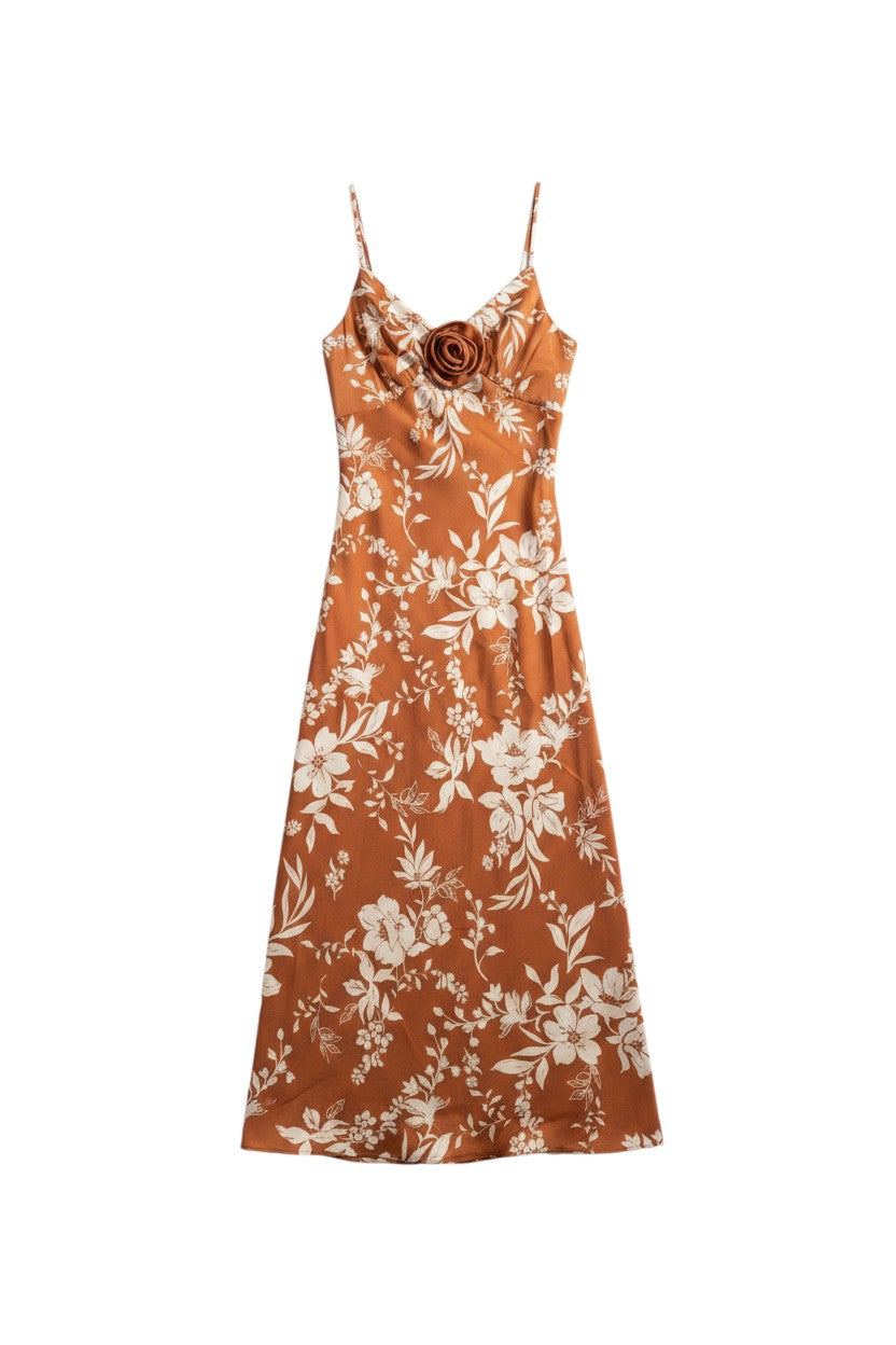 Yanet Collection Shop By the river midi dress in rust orange with white floral print and a central fabric rose detail.