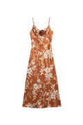 Yanet Collection Shop By the river midi dress in rust orange with white floral print and a central fabric rose detail.