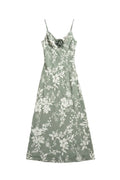 Yanet Collection Shop sage green floral maxi dress with spaghetti straps and a decorative flower detail at the bust.