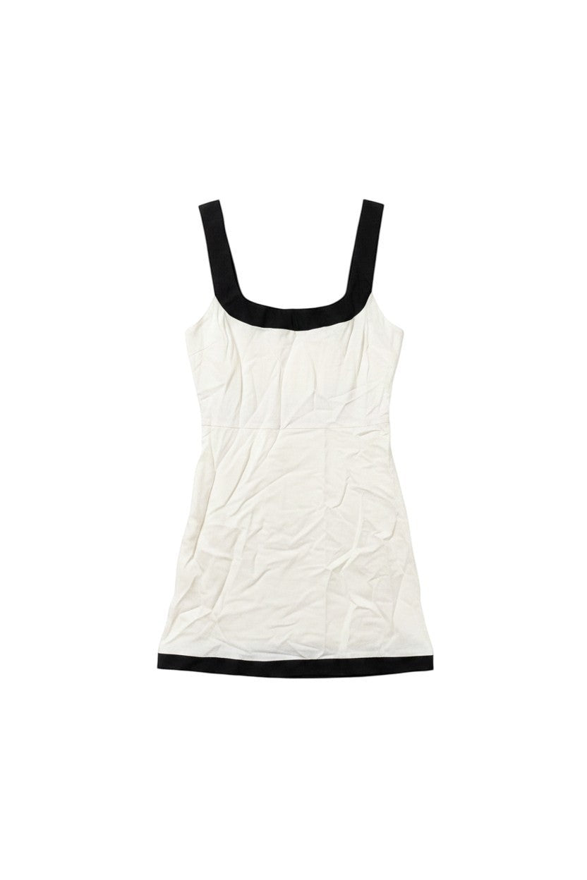 Yanet Collection Shop white mini dress with black trim on the square neckline and hem