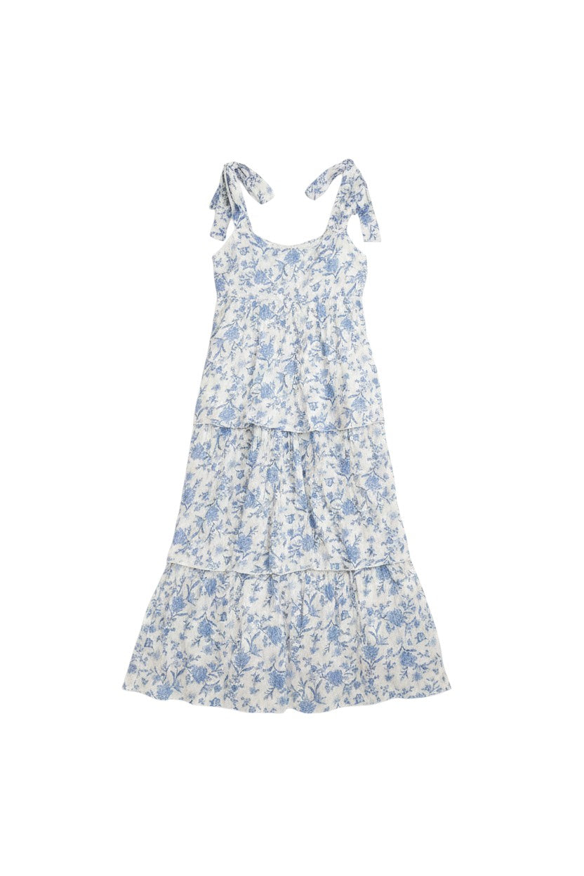 Yanet Collection Shop white tiered midi dress with blue floral print and adjustable bow shoulder straps