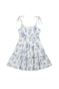 Yanet Collection Shop white mini dress with blue floral print, tiered skirt, and adjustable spaghetti tie straps.