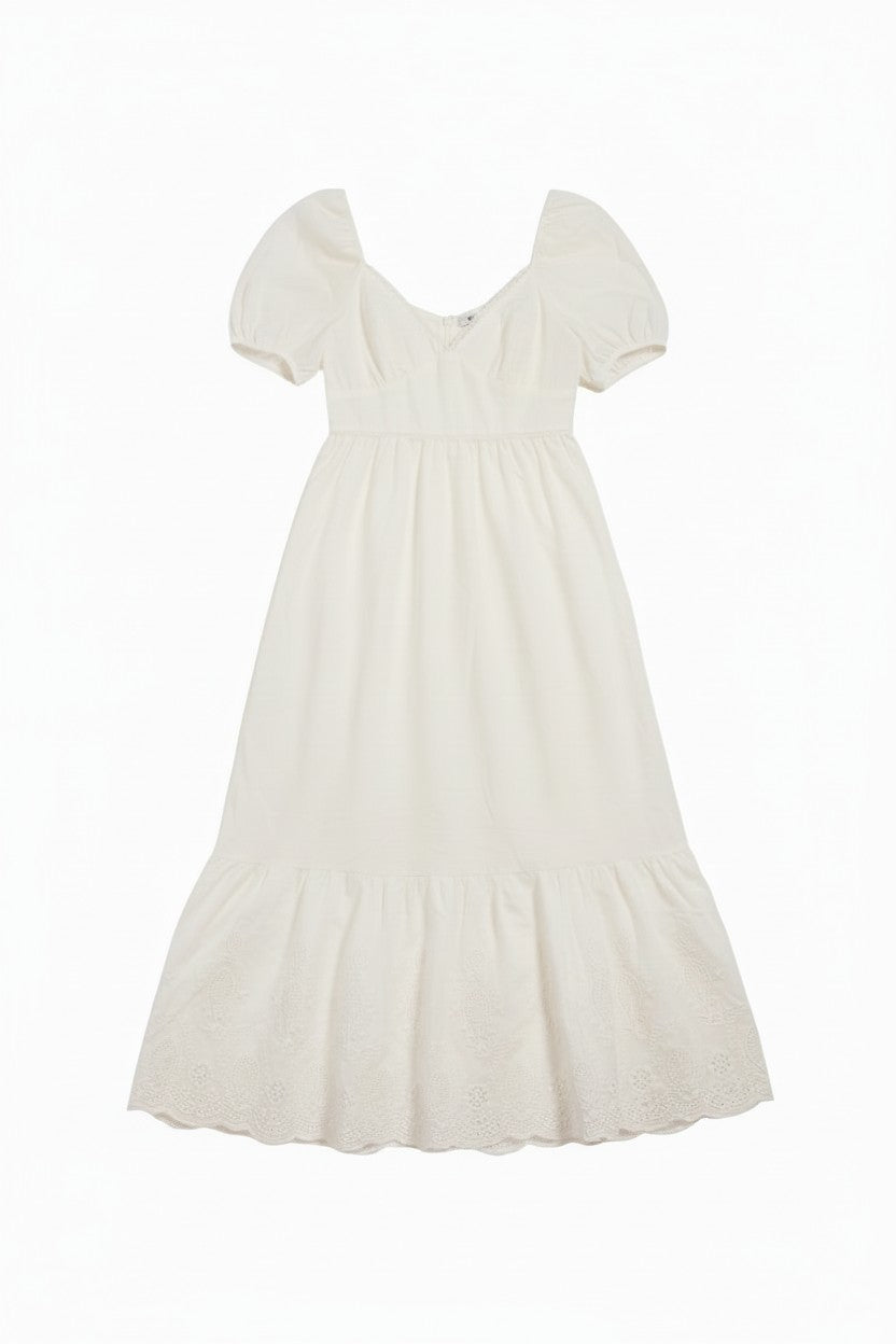Yanet Collection Shop white maxi dress with puff sleeves, v-neckline, and delicate lace trim hem