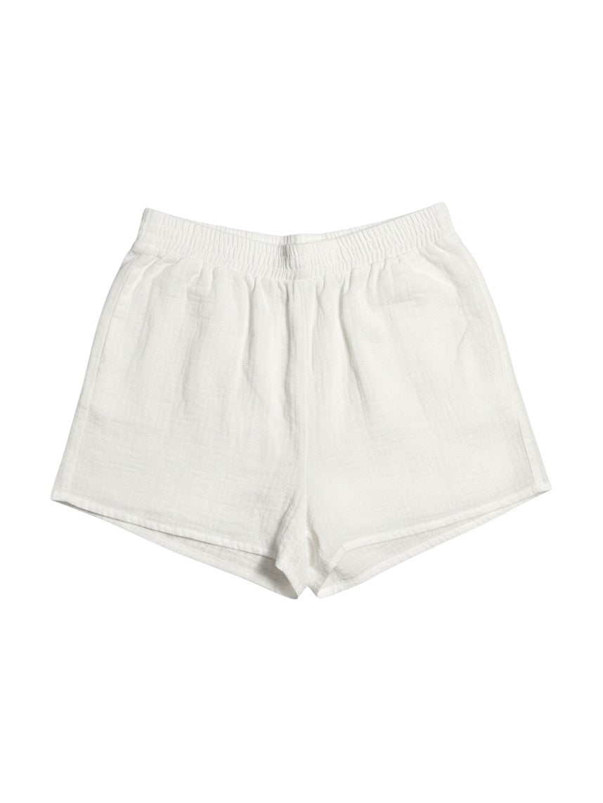 Yanet Collection Shop white cotton muslin lounge shorts with an elastic waistband isolated on a white background.