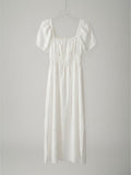 Yanet Collection Shop white maxi dress with square neckline, puff sleeves, and smocked bodice in lightweight fabric.