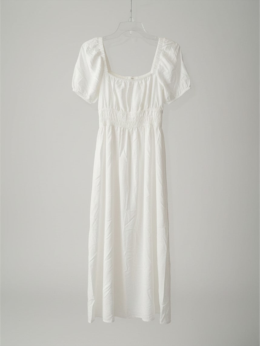 Yanet Collection Shop white maxi dress with square neckline, puff sleeves, and smocked bodice in lightweight fabric.