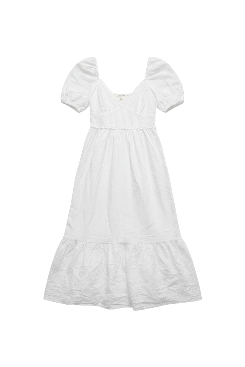Yanet Collection Shop white maxi dress with puff sleeves, v-neckline, and a tiered ruffle hem in lightweight fabric.