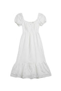 Yanet Collection Shop white maxi dress with short puff sleeves, smocked bodice, and a ruffled hem.
