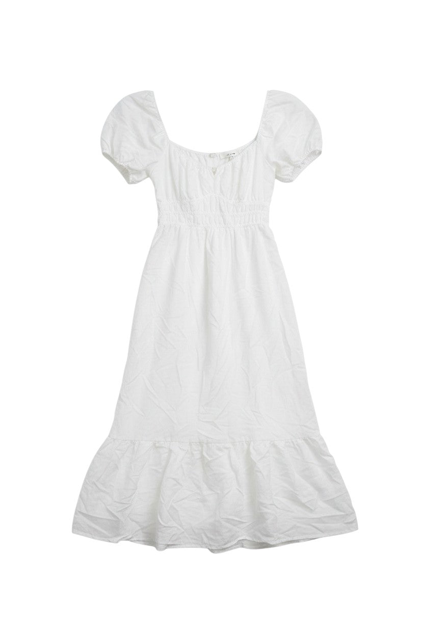 Yanet Collection Shop white maxi dress with short puff sleeves, smocked bodice, and a ruffled hem.